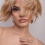 Blonde, tousled wig with layered waves on a model.